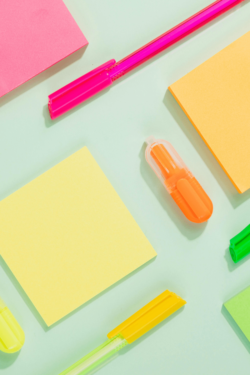 Brightly colored sticky notes of pink, yellow, and orange